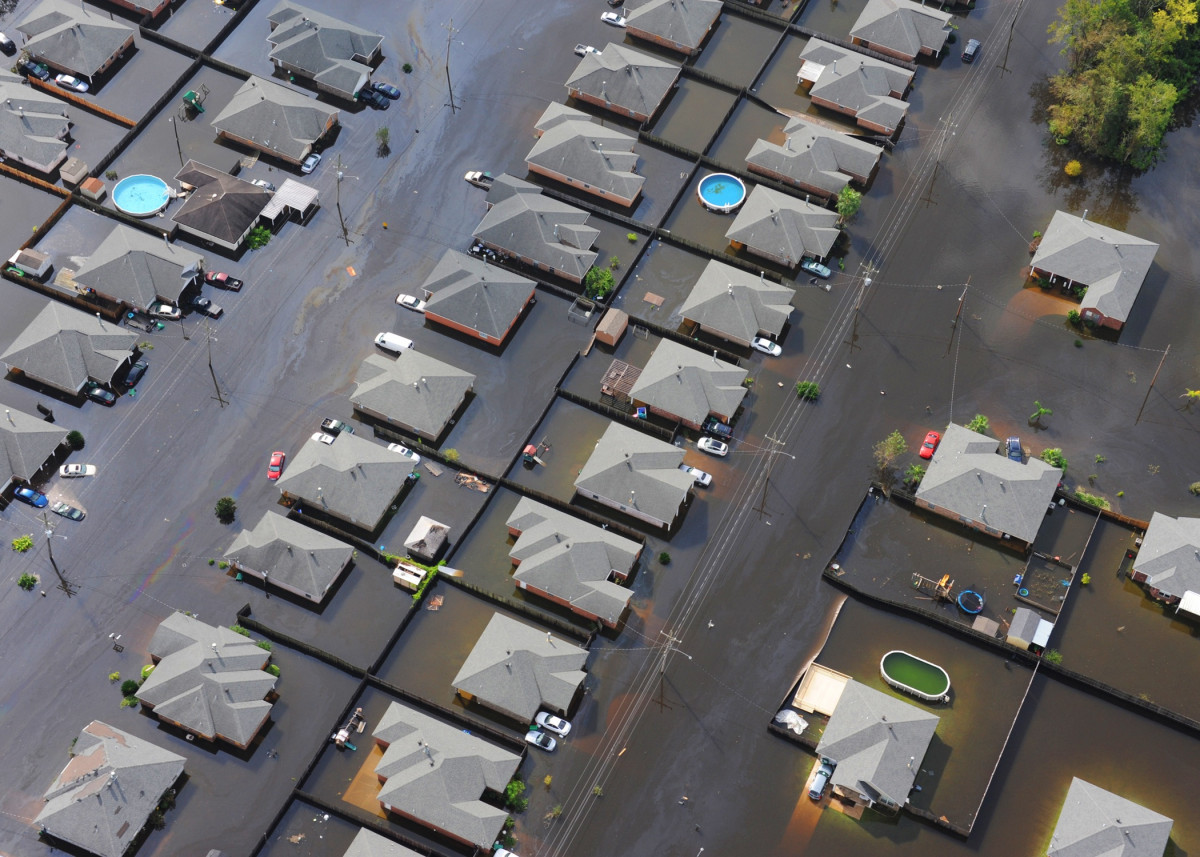A suburban block of homes standing in floodwaters.